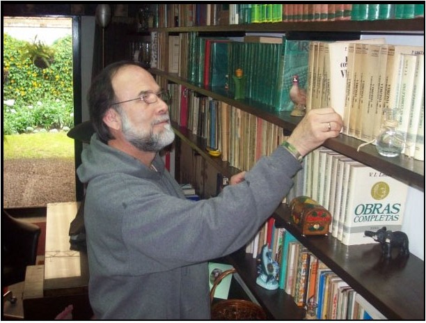 TransSend founder consulting books in a personal library
